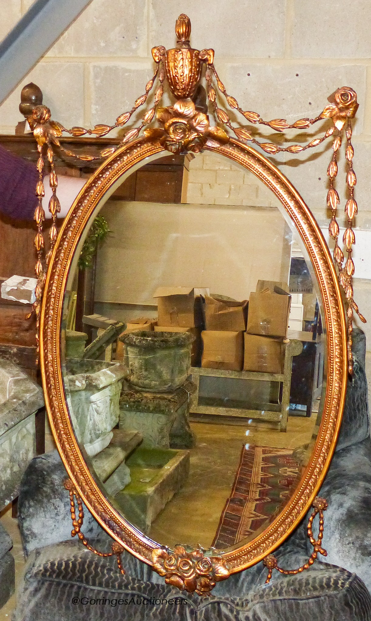 An oval Victorian style gilt wall mirror, width 70cm, height 120cm